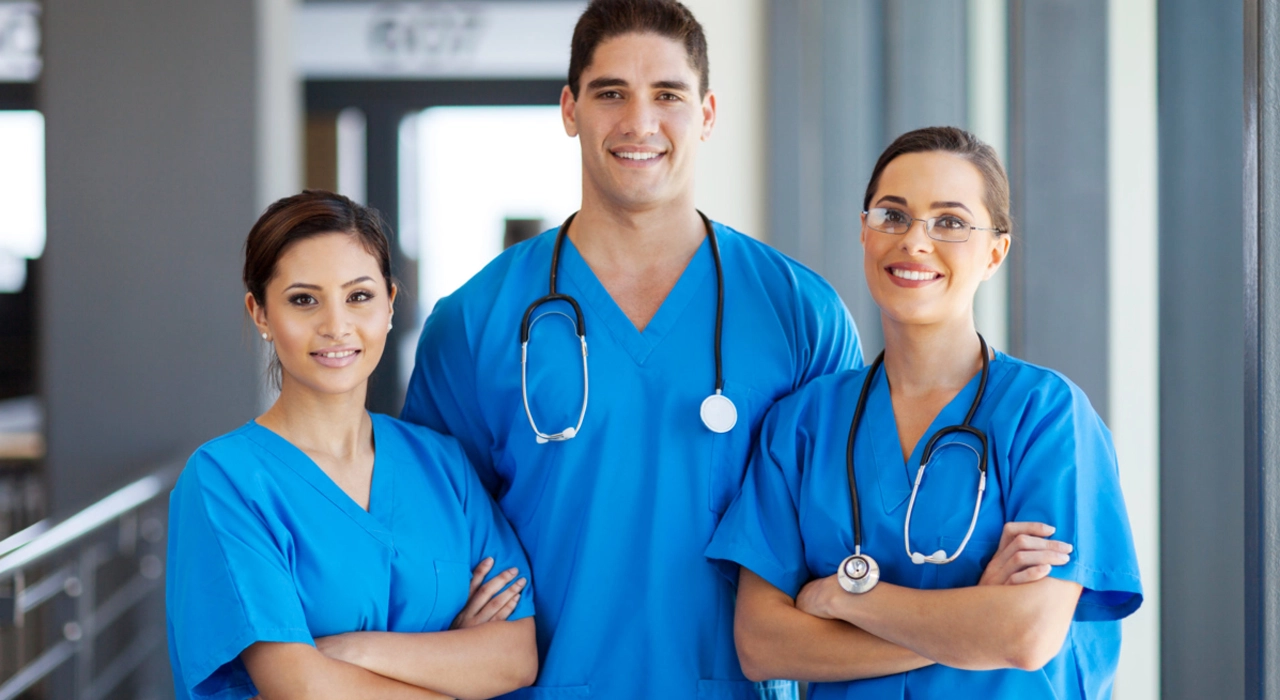 Group of professional doctors standing and smiling for a photo