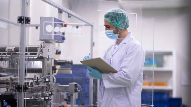 Hospital worker checking medical equipment logistics while holding a clipboard