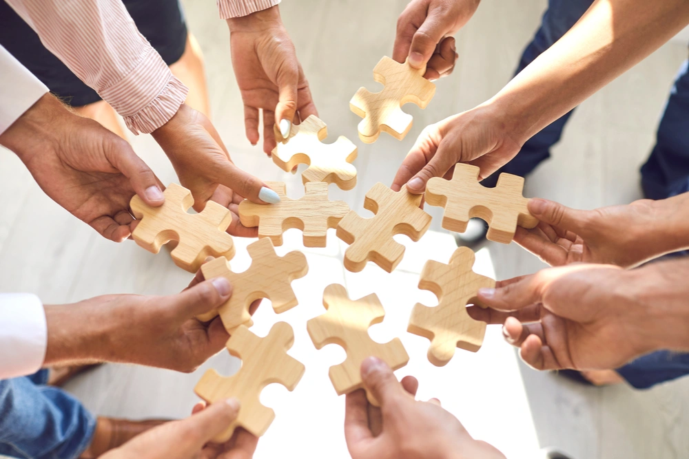 Employees collaborating on a jigsaw puzzle during a team-building activity