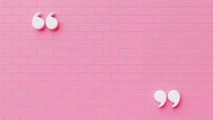 Pink brick wall with inspirational quotes displayed