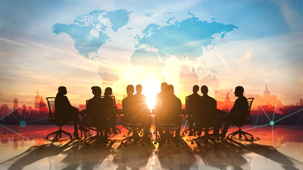 Double exposure image combining a world map, business meeting at a round table, and businessman discussing unfundable gaps