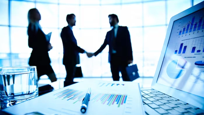 Business partners shaking hands during a meeting to finalize an agreement