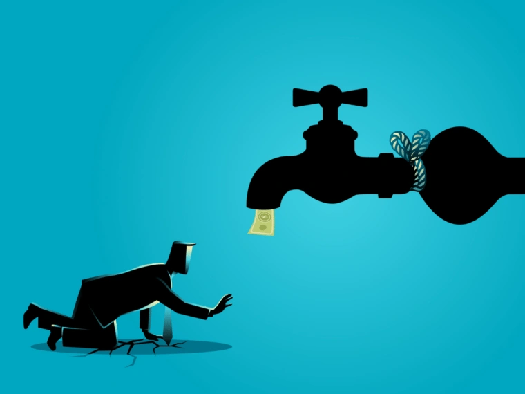 Exhausted businessman walking toward a water tap flowing with money